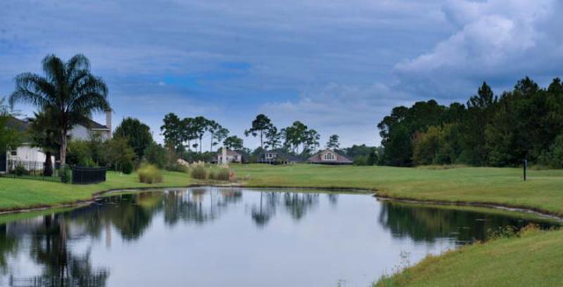 Course greens over a reflective lake